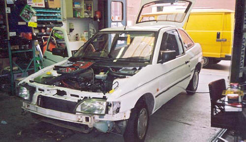 Various stages of construction of three identical Ford Escort Cosworth rally